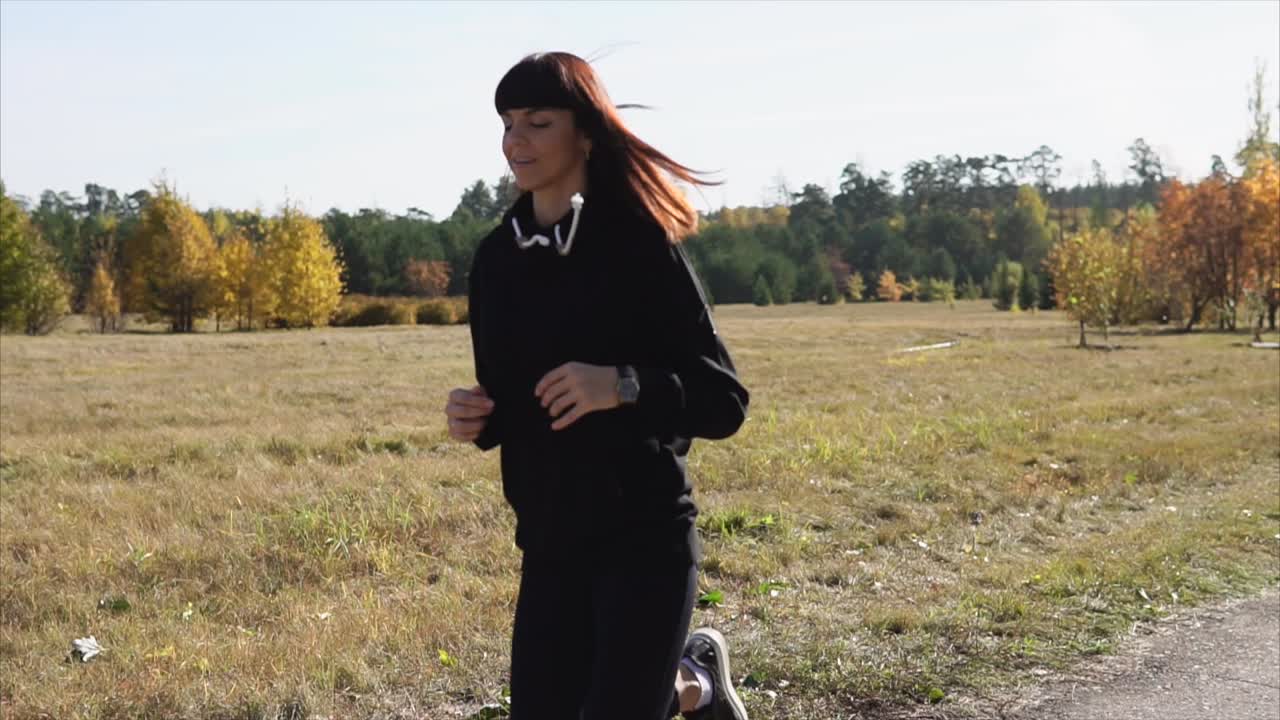 Woman jogging in autumn park
