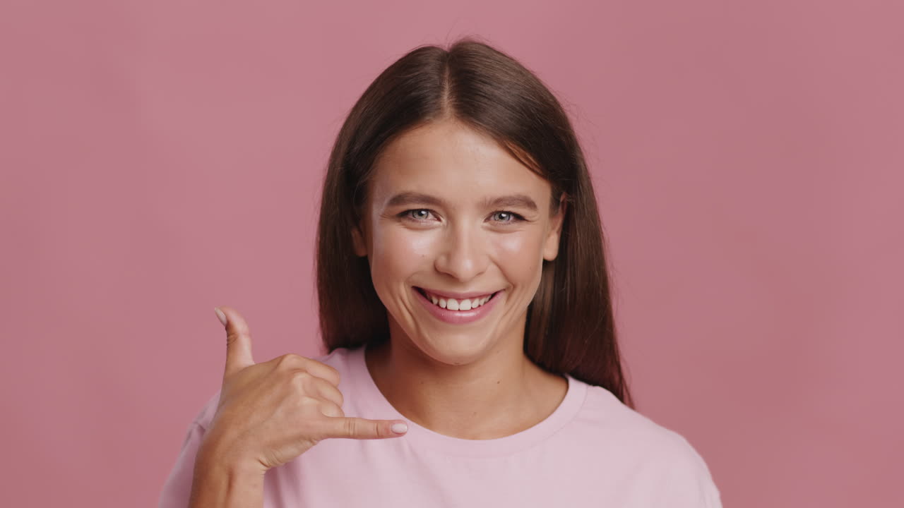 Happy Woman Making Phone Gesture