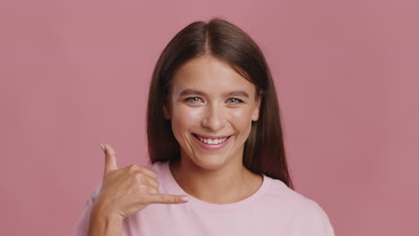 happy woman making phone gesture
