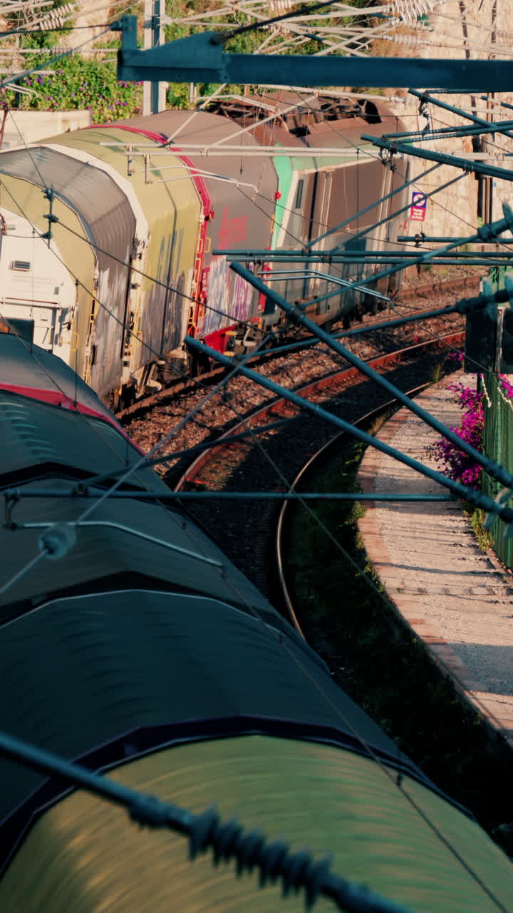 Train going moving near a beach in Villefranche sur Mer, France. Vertical