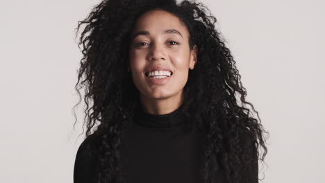 african american woman smiling over white background.