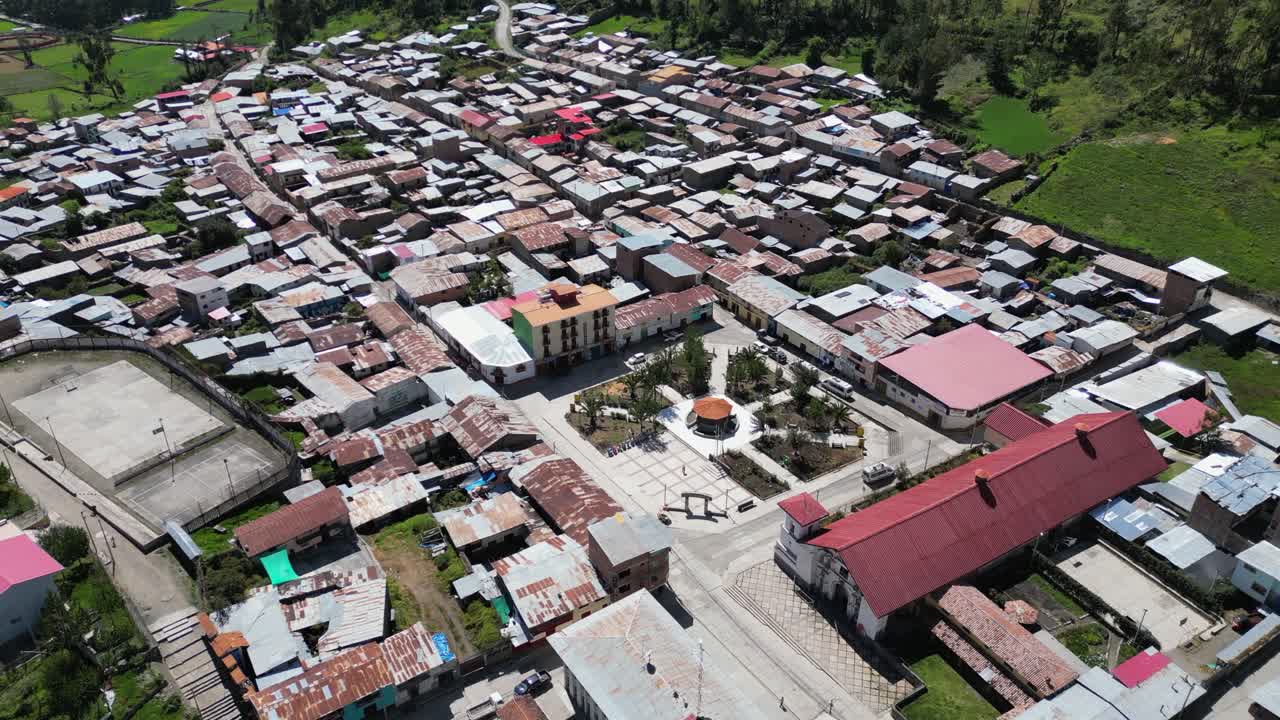 Aerial circles charming central plaza in Peru mountain town, Cajatambo
