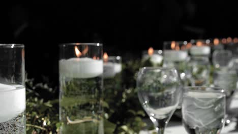 gorgeous head table flat lay of white floating candles in crystal vases with beautiful floral arrangements surrounding them at strathmere wedding and event center in ottawa, canada