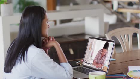 Caucasian-female-teacher-using-laptop-on-video-call-with-female-student