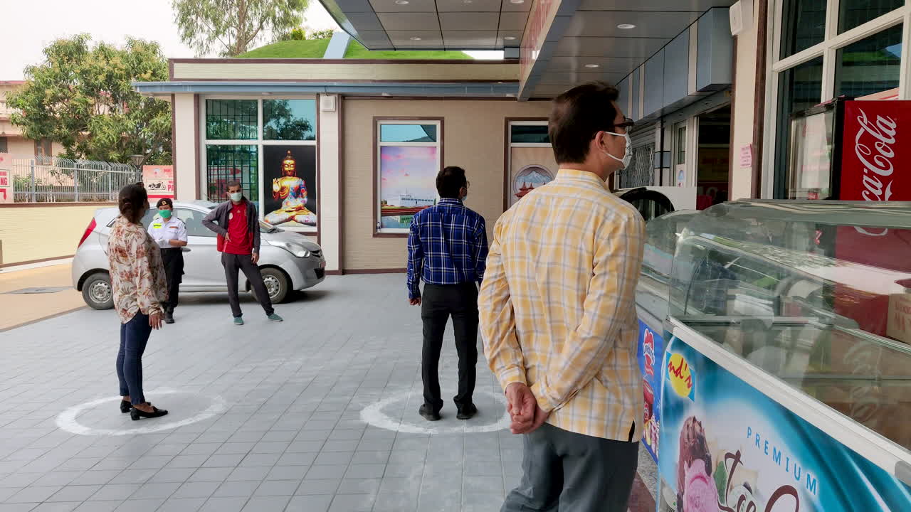 People observing social distancing in a public area in India