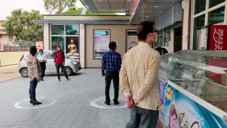 people observing social distancing in a public area in india
