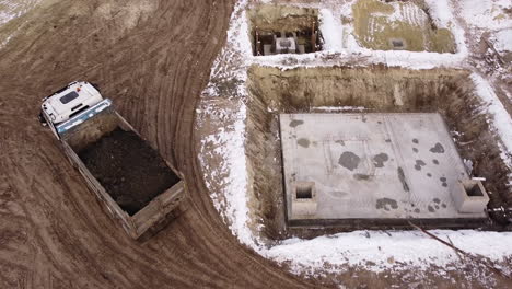 construction site in winter with dump truck