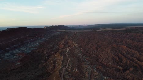 Wide-aerial-landscape-shot-of-mountainous-terrain-in-a-Utah-desert