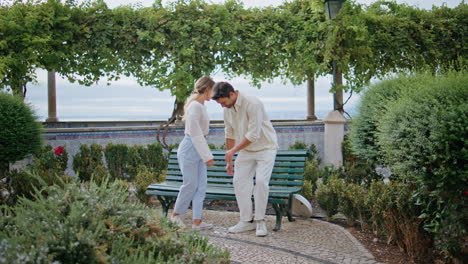 tender lovers walking park holding hands at vacation back view. couple strolling