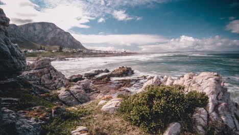 long exposure timelapse of waves crashing on shoreline and sea spraying on lens