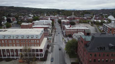 flying over montpelier city street intersection and building rooftops