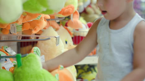 boy choosing toy in the shop