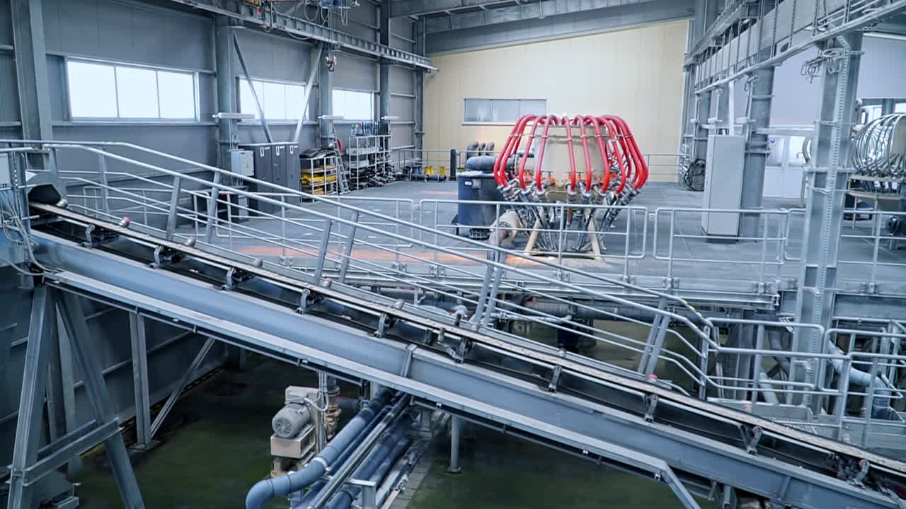 Technological equipment at modern clay processing factory. The conveyor line with pieces of clay minerals going up.