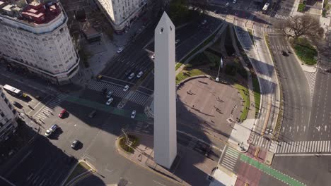 aerila top down shot famous obelisk monument tower in buenos aires surrounded by traffic on 9 de julio avenue in buenos aires - tilt up shot