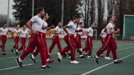 students in uniform performing exercise routine