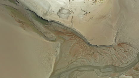 Aerial-top-down-view-showing-the-natural-pattens-in-the-costal-sand-at-low-tide