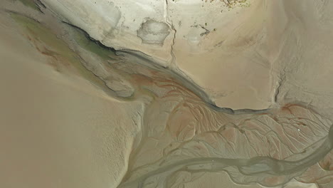 aerial top down view showing the natural pattens in the costal sand at low tide