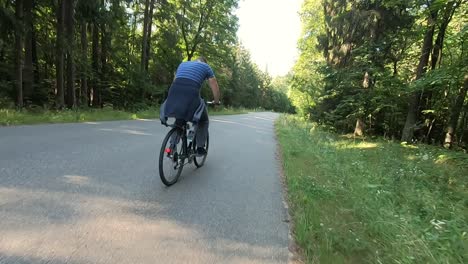 a man rides his bike through the forest