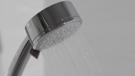 shower head in bathroom with water drops flowing. water drops in the shower head