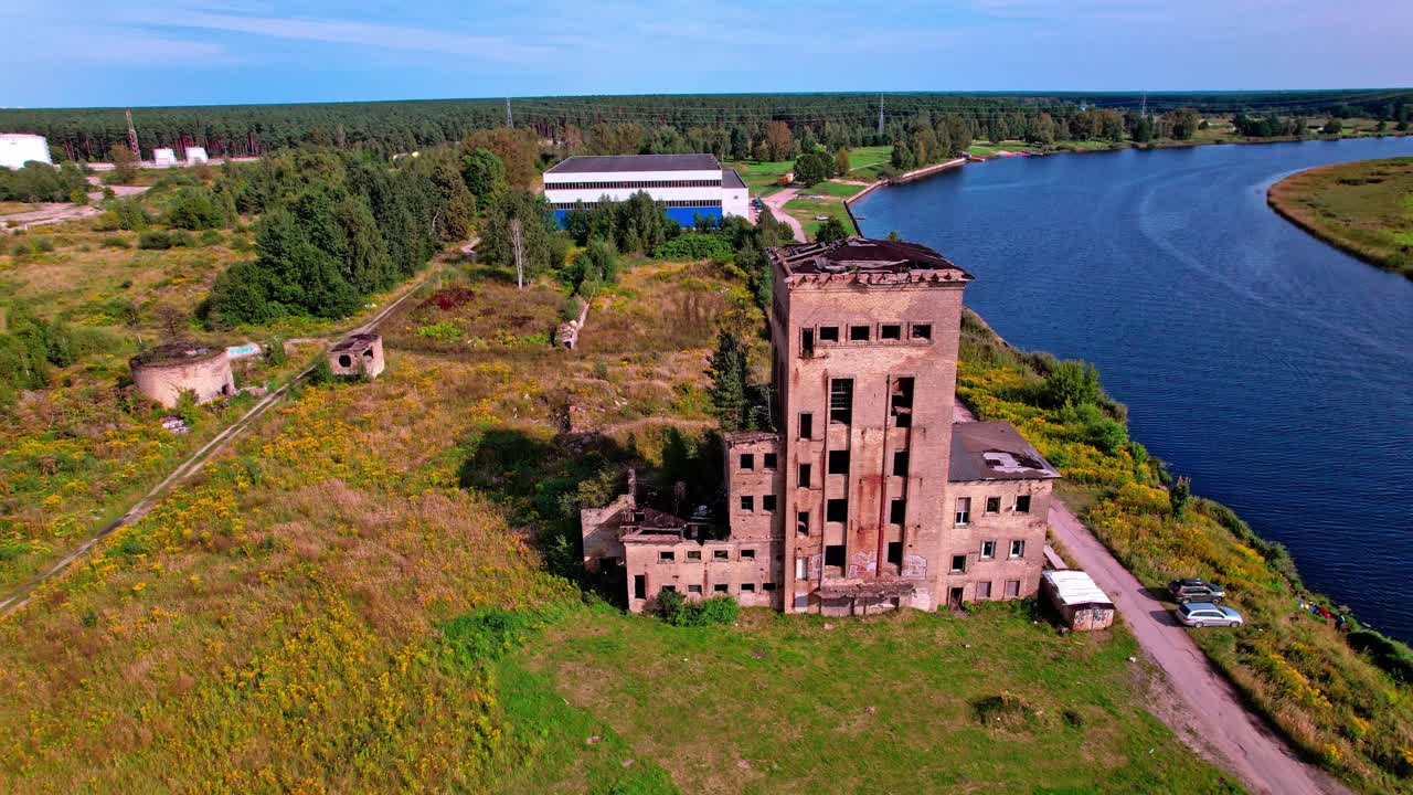 Exploring the abandoned building near a river in Latvia's landscape