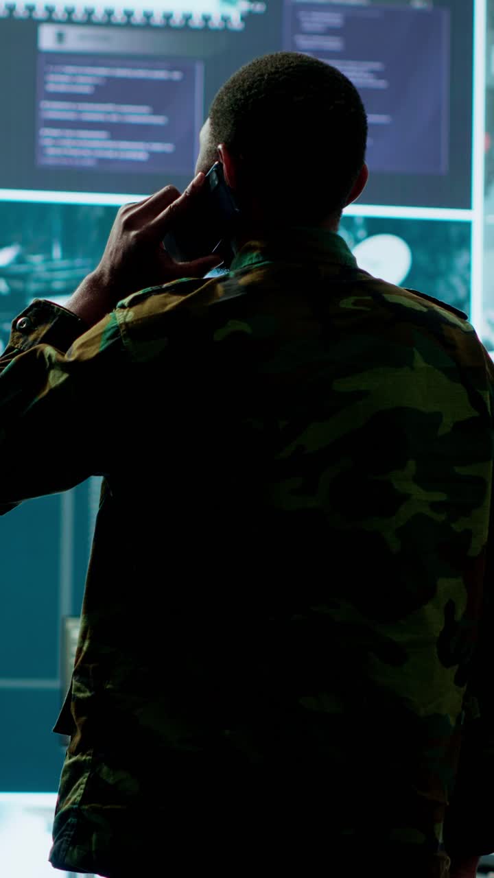 Vertical Video Military man answers phone call in a mission control center