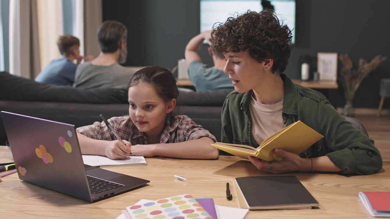 Mom And Daughter Studying While Boys Watching Hockey