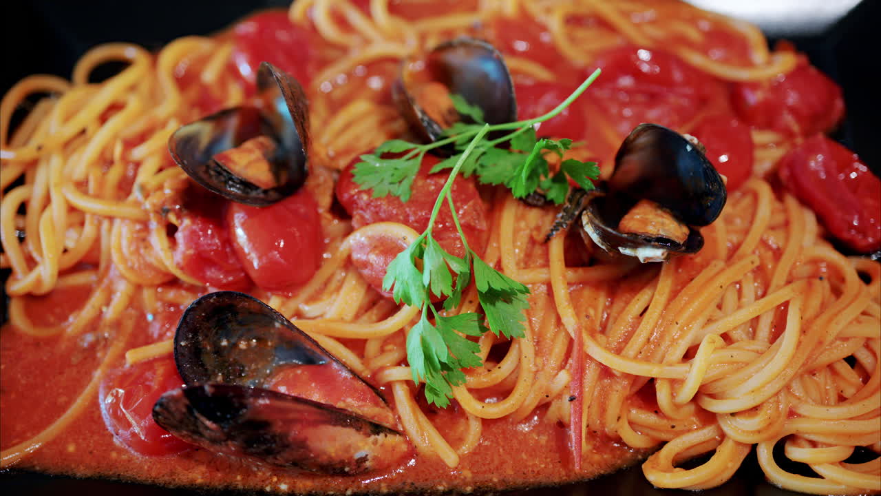 Close up of pasta with tomato sauce and mussels
