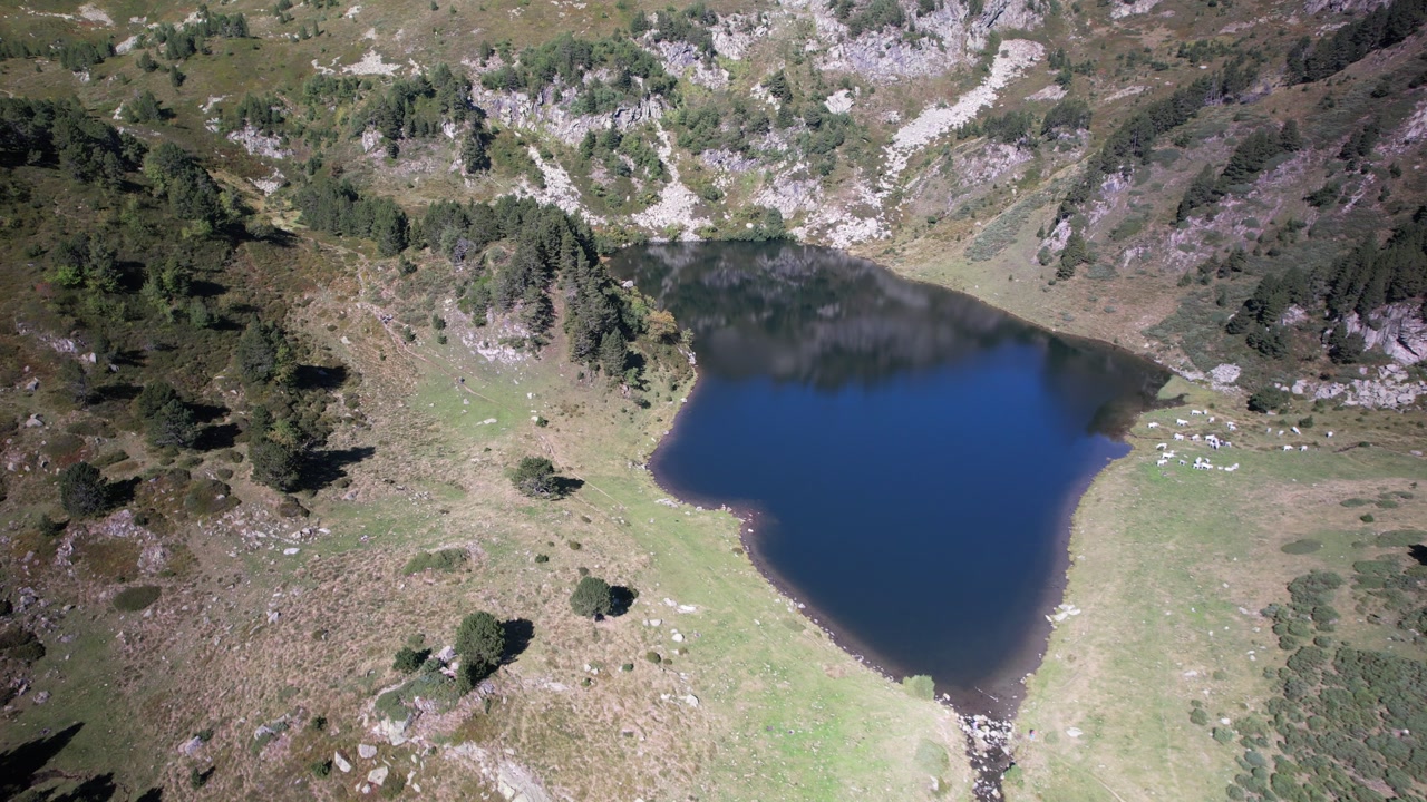 Aerial views of an alpine lake in the french Pyrenees at low altitude