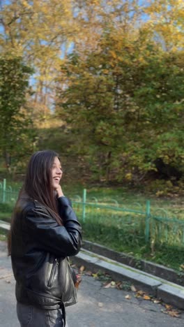 woman enjoying autumn park walk