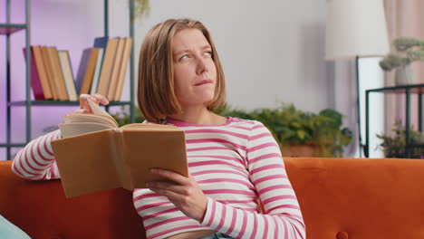 Mujer-Joven-Relajante-Libro-Interesante-Pasando-Páginas-Sonriendo-Disfrutando-De-La-Literatura-Descansando-En-El-Sofá