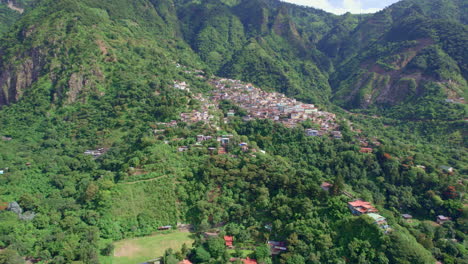 drone footage of volcanic mountainside indigenous town santa cruz la laguna, guatemala in lake atitlan in central america highlands surrounded by lush rainforest