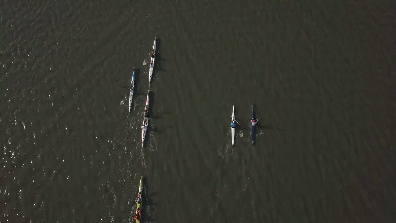 Drone footage of paddlers paddling in a race on a lake