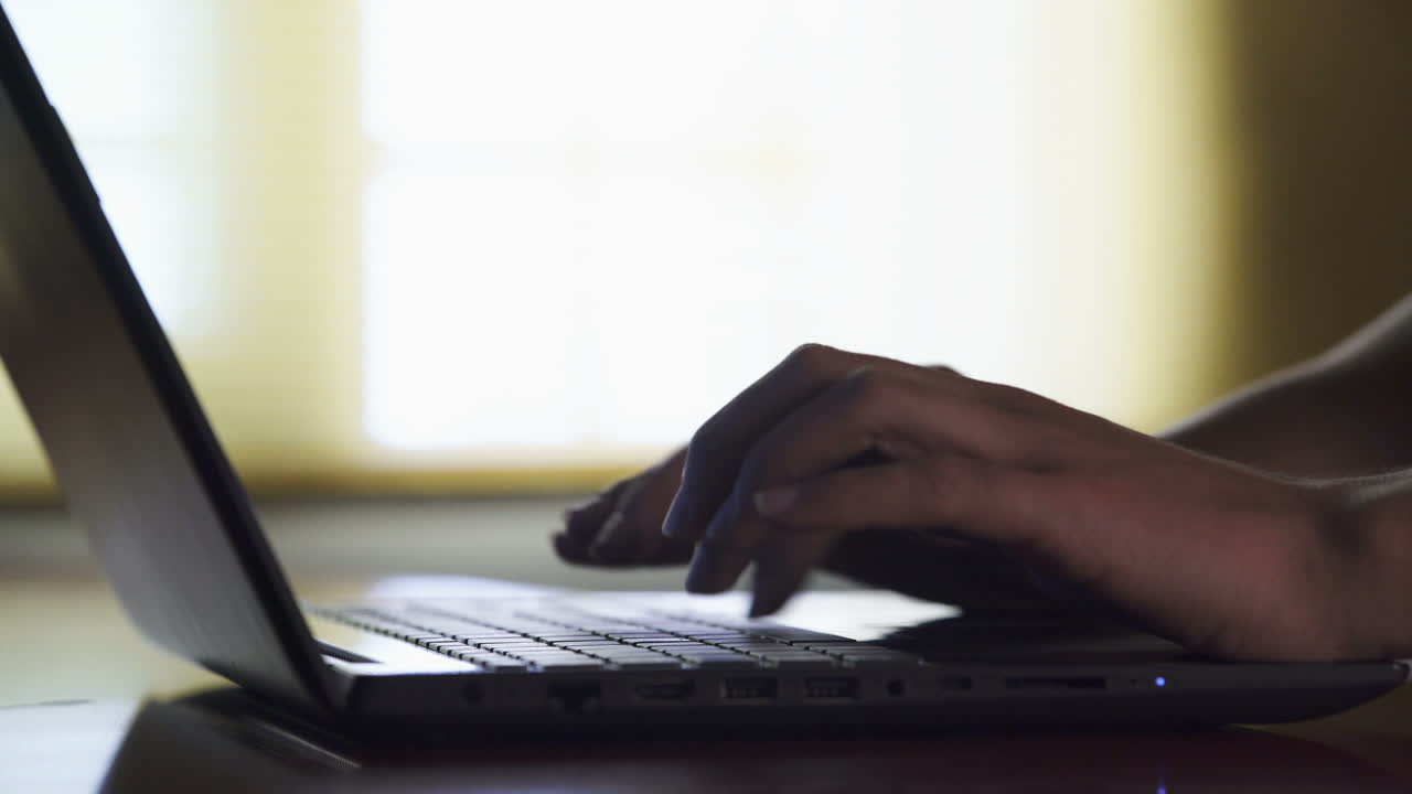 mãos a digitar num portátil