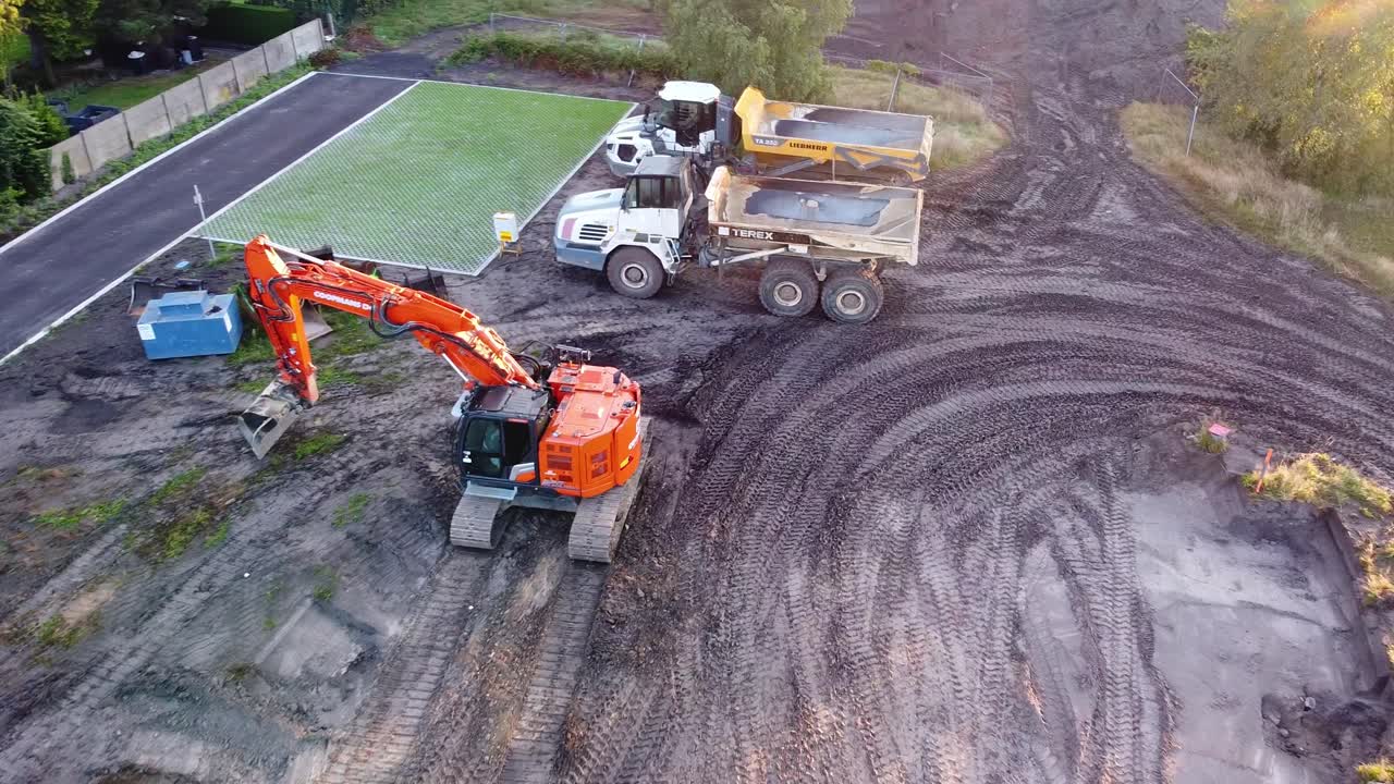 Construction site with Trucks, Excavators, Loaders, To Build New Apartment Block.