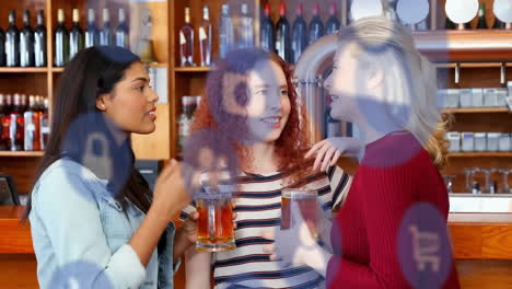 Animation-of-media-icons-over-diverse-female-friends-talking-and-holding-beer