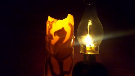 LOOPING---candle-and-oil-lamp-in-a-dark-room-flickering-with-a-warm-calm-feeling