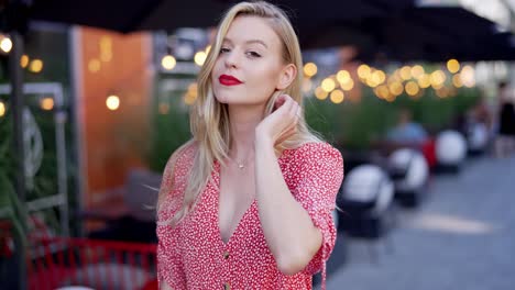 blonde woman in red dress outdoors