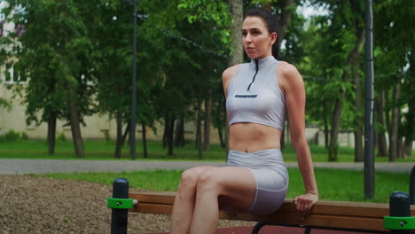 Una-Atleta-Realiza-Ejercicios-Inversos-En-Un-Banco-De-Un-Parque-A-Cámara-Lenta.-Hermosa-Mujer-Practicando-Deportes-En-El-Parque