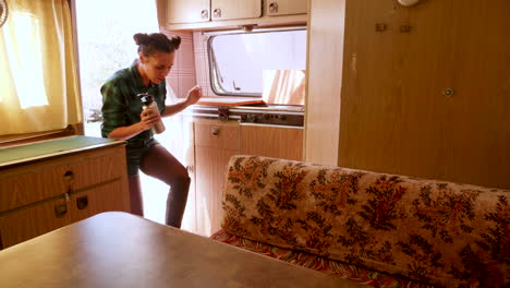 couple after a walk in the mountains entering in their retro camper van