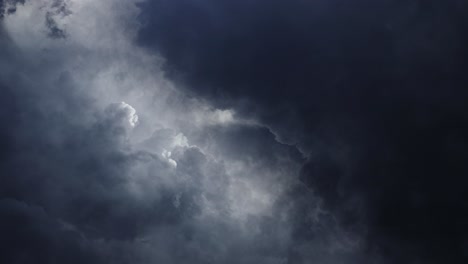 flying through in dark cumulonimbus clouds with lightning flashes