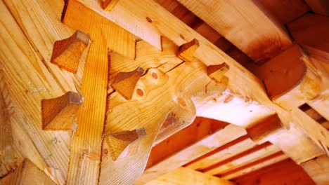 Moving-shot-of-a-wooden-structure-supporting-a-roof