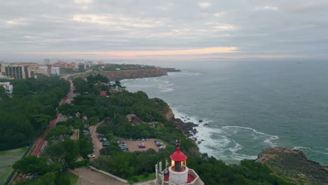 twilight coastal town washed by  ocean water. lighthouse on seashore