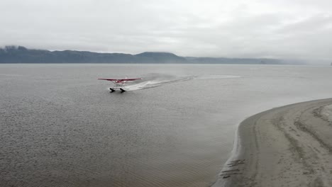 floatplane taxiing on water surface for take off in alaska