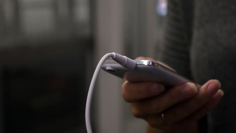 woman choosing music tracks on mobile