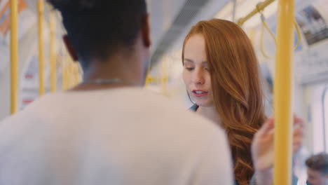 young couple of vloggers or social influencers travelling through city on subway for social media