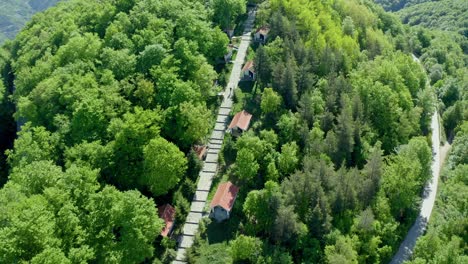 ascending top down shot of person walking on path at krastowa gora on green mountain krastov vrah during sunny day