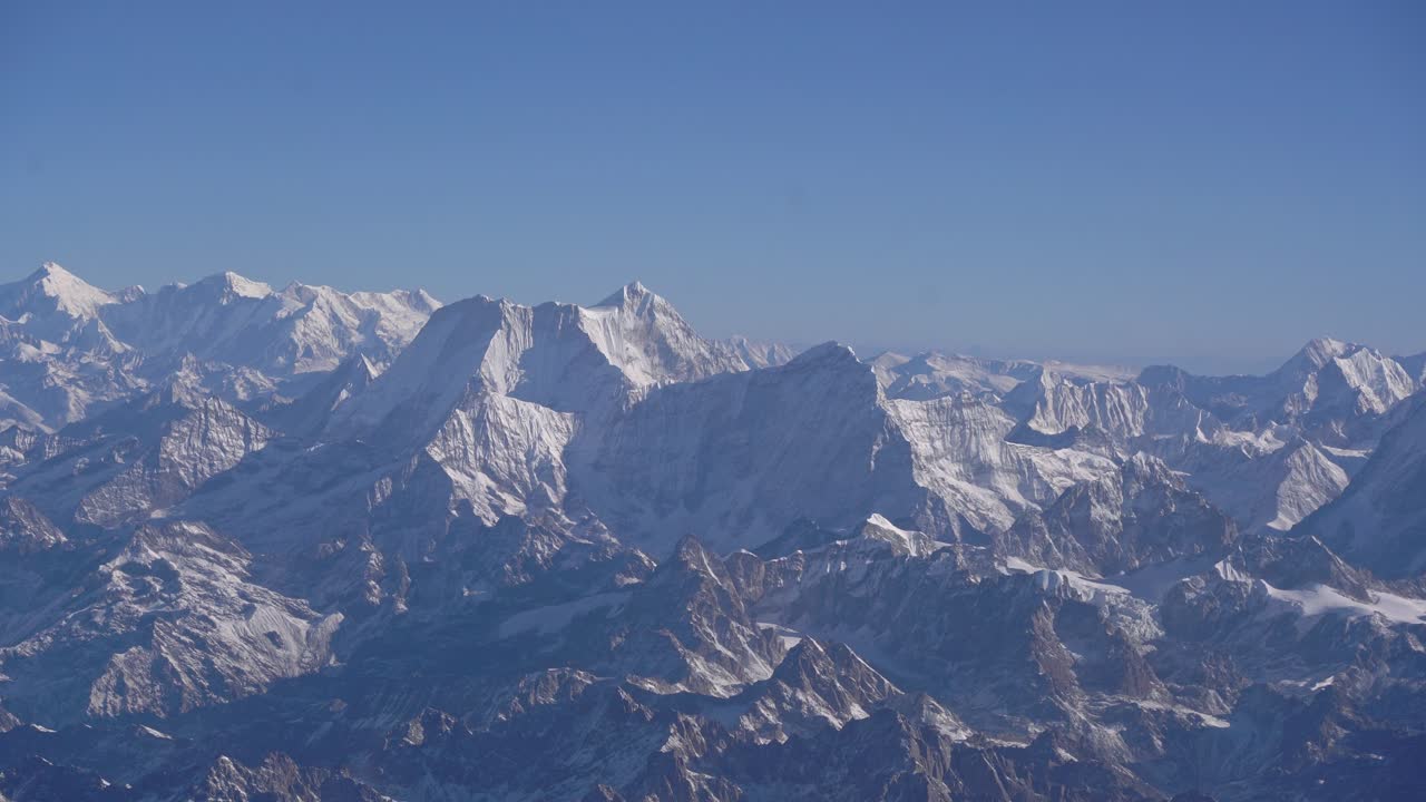 Aircraft view of Nepal Himalayas showing mountain range, cloud formations, and breathtaking natural environment from above