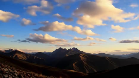 enjoy a breathtaking view of the andes mountains at sunset, highlighted by vivid orange and purple hues in the sky. the rocky landscape adds to the natural beauty of this peaceful setting.