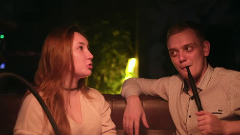 couple relaxing at a hookah lounge