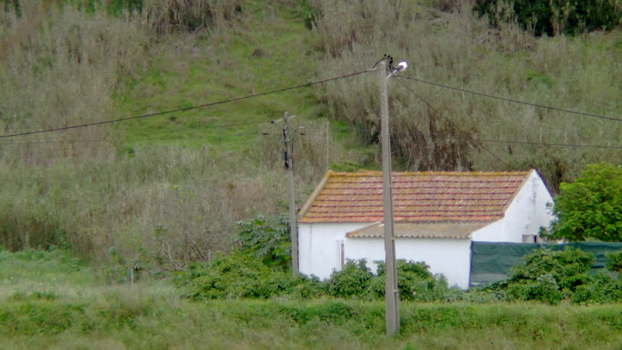 A little white house on the field.